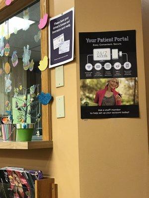 Front desk. Signage for check-in and patient portal.