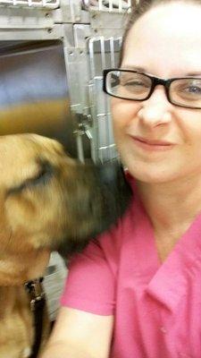 Tiffany, a veterinary technician, getting some kisses from our patient!