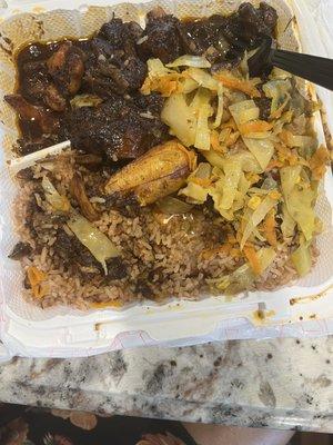 Oxtails, rice and beans, cabbage with plantains.