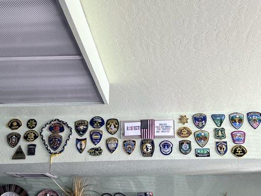 First responder and military badges on the wall