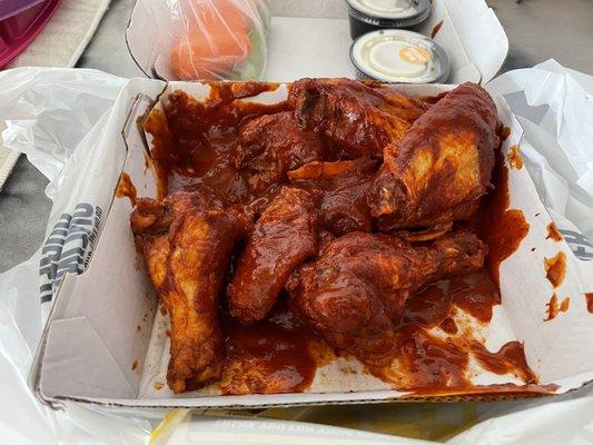 Carolina Reaper wings with extra sauce. They're pretty spicy but pretty tasty too.