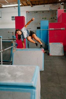 Girl vaulting through the obstacle course during her parkour class at Freedom in Motion parkour gym in Murritea