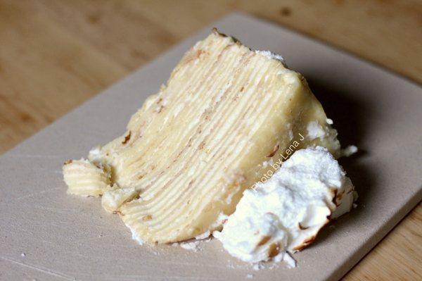 Slice of lemon meringue crepe cake - crepe layers are very thick