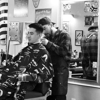 Conner the barber cutting.