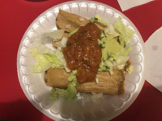 Tamales with lettuce, hot red salsa, and creamy green salsa