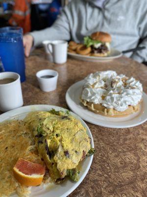 Bacon Avocado Omelet with hash-browns, Banana Walnut Caramel Waffle & Double Bacon Cheeseburger with an egg on top and a side of onion rings