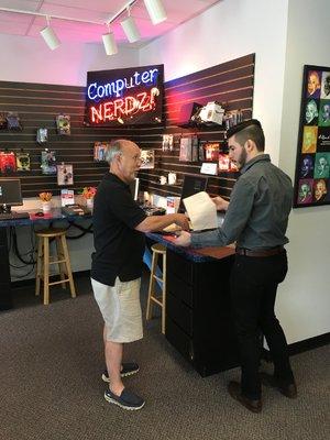 Senior Professional Nerd, Randy helps a Client at Check out.