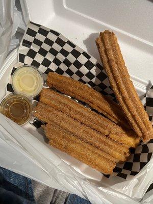 Churros with Caramel and Lechera sauce on the side.