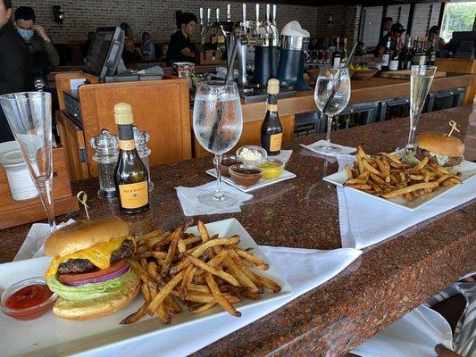 Burger and fries with cheddar cheese.