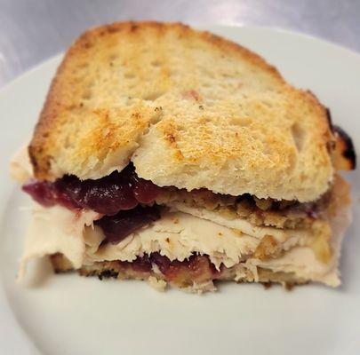 Our Famous "Turkey Gobbler," Sandwich! Shaved Turkey Breast, Homemade Stuffing, Cranberry Sauce, Mayo on Freshly baked white bread.