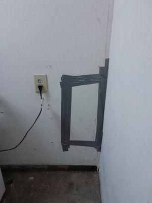 Hole to get access to water lines and back of fixtures in a T-wall