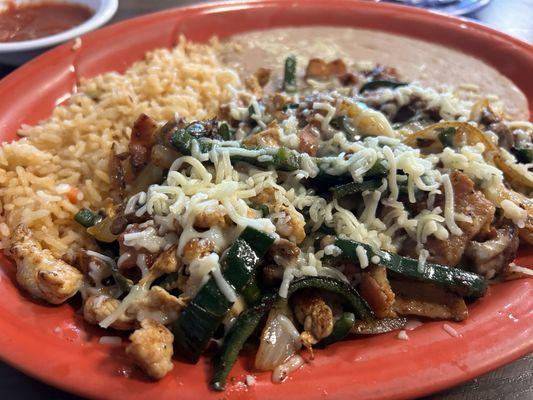 ALAMBRE $12.99 Chopped Steak, Chicken, Bacon, Poblano Peppers, Onions, and Cheese. Served with Rice and Beans