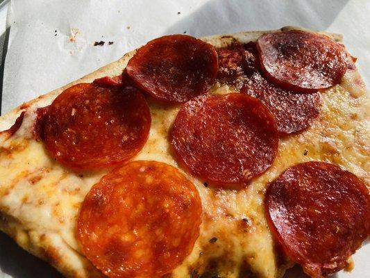 Thin crust slice of pepperoni