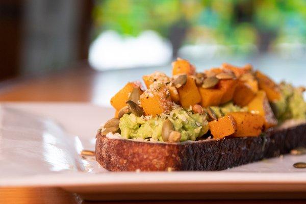 Avocado Toast! With roasted butternut squash, smashed avocado, house made almond ricotta, and toasted pepitas on a thick slice of sourdough.