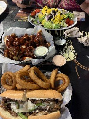 A Greek salad, BBQ wings & a great Philly cheese steak & excellent onion rings. The dill sauce was the Best.