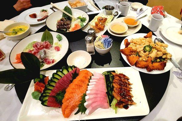 Sashimi plate, shrimp toast with fried squid, pan seared ahi tuna, tuna avocado sushi appetizer