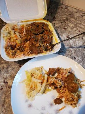 Curried Goat with rice, and steamed cabbage