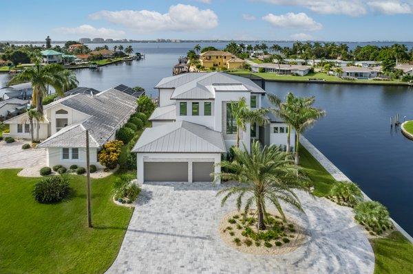 Contemporary two-story new home with more than 3,900 sq. ft. of living space built along intersecting canals in Cape Coral, FL.