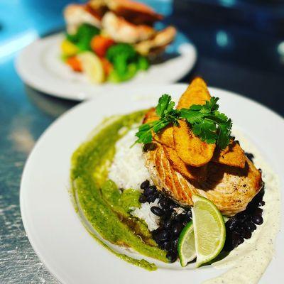 Fresh swordfish with Zhoug, Black Beans, Rice, and Plantains.