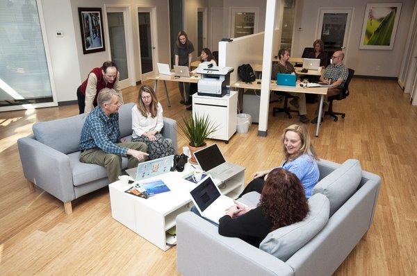 Part of BDA's open, shared coworking space with reserved desks and lots of sunlight.