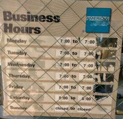 Business hours posted on door.