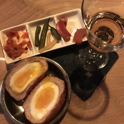 Pickles and scotch egg with one of the drinks