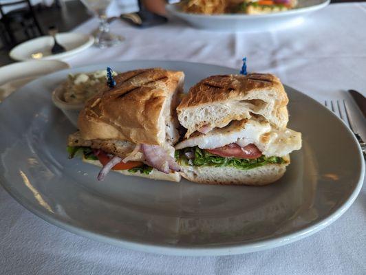 Chilean sea bass sandwich with potato salad on the side