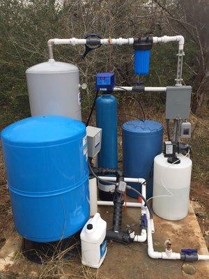 86 gallon pressure tank, peroxide injector, 120 gallon retention tank, 5 micron sediment filter, and a softener on a slab with the well