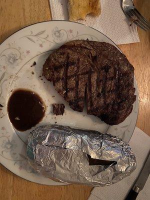 Supposed to be "blackened" Rib eye... a delicious steak, but not blackened.  Look at the size of that potato.