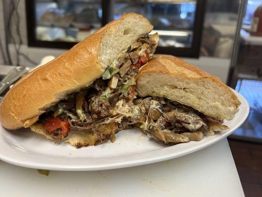 Italian Cheesesteak w/ thinly sliced beef, caramelized onions, marinated roasted reds, sauteed mushrooms, aged provolone, basil aioli.