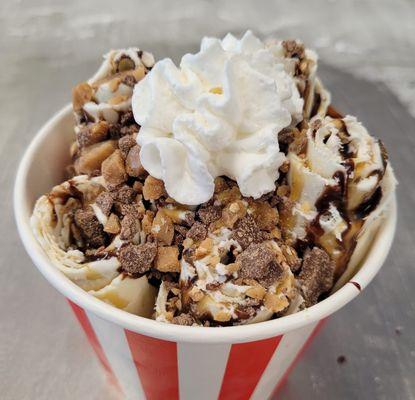 Cookie dough chopped and rolled, drizzled with chocolate and caramel, topped with Heath crunch and whip cream.