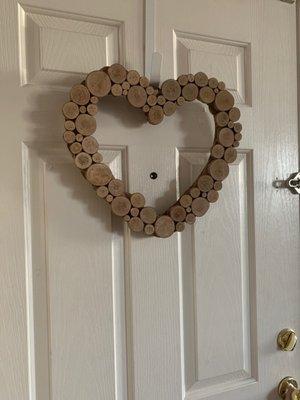 Heart shaped wreath made out of sliced wood. Extremely versatile and only $34!