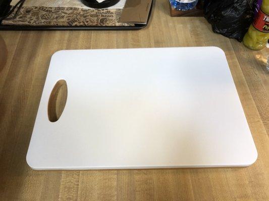 The plastic surface side of the cutting board.