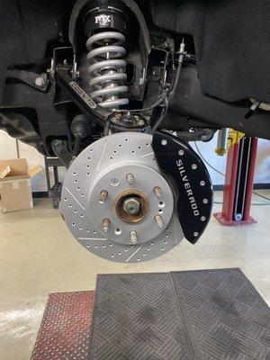 R1 Concept Brake Pads and Rotors on a 2014 Silverado with caliper covers installed