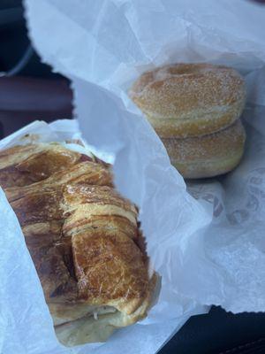 Two sugar donuts and a #2 ham and cheese bacon croissant