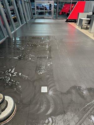 Audi dealership tile floors getting cleaned in the show room in Los Angeles.