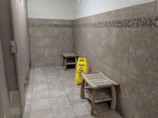 Waiting area with benches to place your things outside the shower