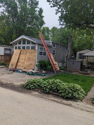 They laid down tarp and put plywood over windows to protect garden and house.