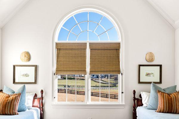 The natural tones and texture of these woven shades are the perfect accent for the traditional decor of one of our most recent installations