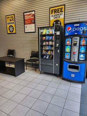 Other side of small waiting area with vending machines