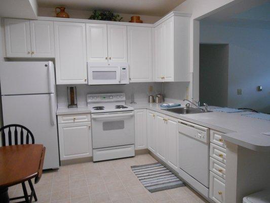 Spacious kitchen with GE appliances and peninsula.