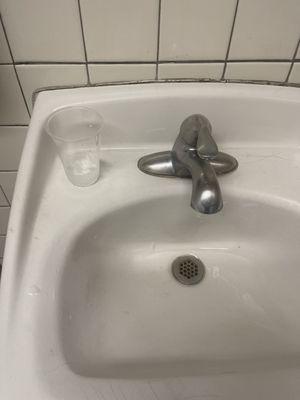 Used cup left in bathroom