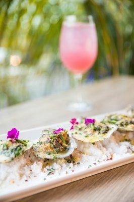 Oyster Côte d'Azur - half dozen grilled oysters, wilted arugula, garlic, feta, pernod cream sauce, shallots, lemon, herb breadcrumbs.