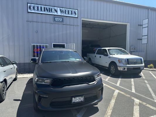 Finished 2021 Dodge Durango. Had Front end damage. Replaced hood and repaired bumper.