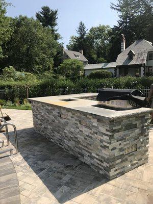 Outdoor living area with gril, counters, bar and more