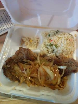 Steak with sauteed onions served with rice, salad 2 tortillas.