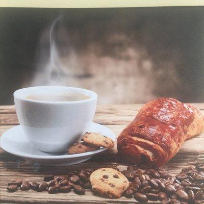 Serving Italian coffee Lavazza with French chocolate croissant freshly baked every morning