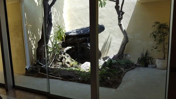 A rock fountain outside of the main lobby, first thing you see when you walk in the door.