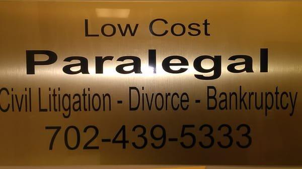 This sign clearly says she does LETIGATIONS. Only Attorneys can do litigations not paralegals.