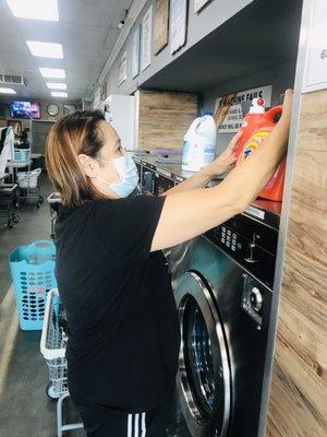 This woman removes other people's clothing from machines, claiming that she needs the machines.